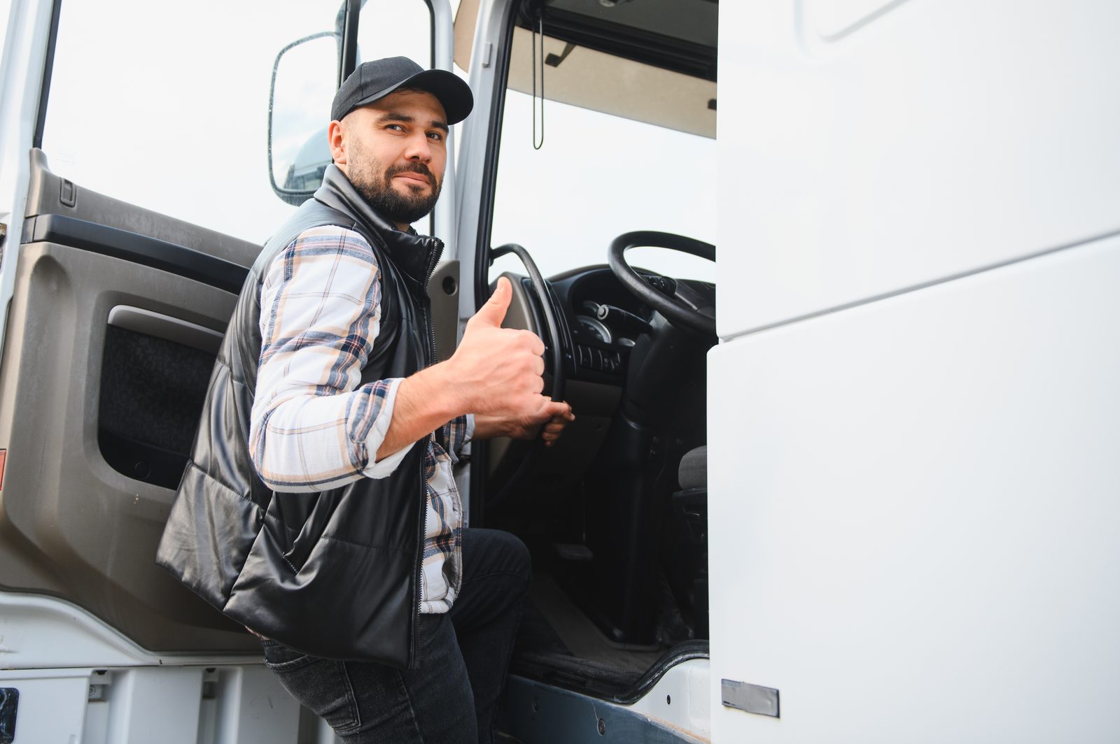 Truck driver leaning out of his cab