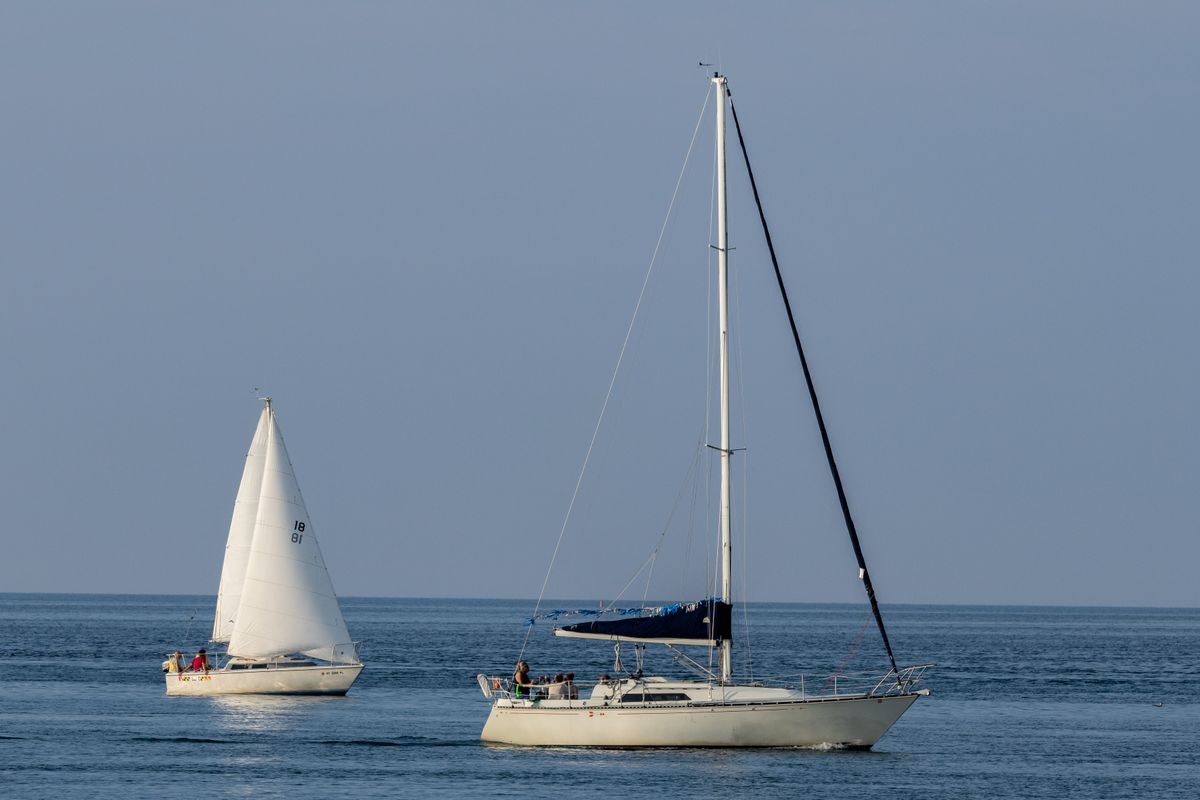 Sample sailing charter website: two sailboats under sail on calm water